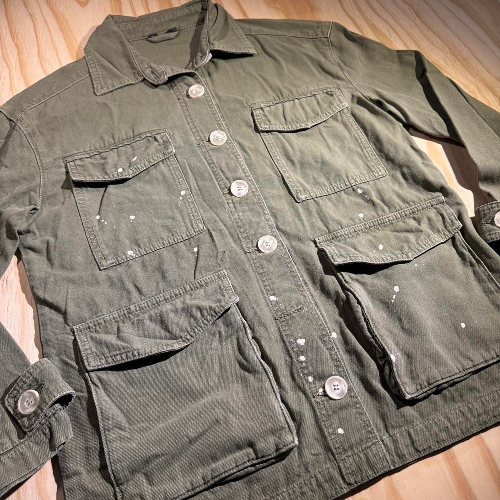 Green military style jacket with white paint